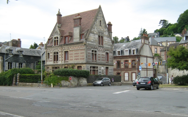 a large french style house on a broad street